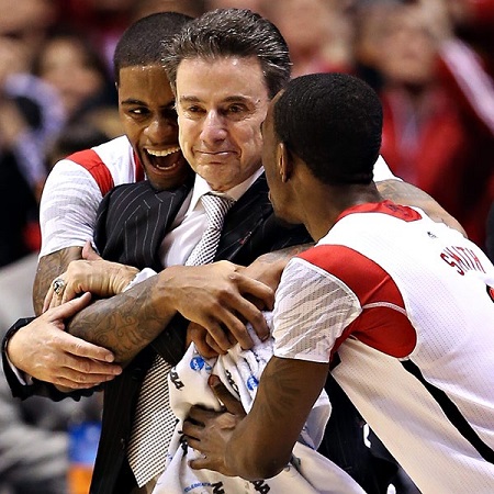 Rick Pitino being hugged by two Louisville players.